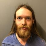 Newport Man Arrested After Authorities Discover Weapons Cache Linked to Alleged Extremist Online Threats